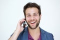 Cool young man smiling with mobile phone on white background Royalty Free Stock Photo