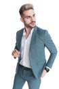 Cool young man in suit with untied shirt holding hand in pocket Royalty Free Stock Photo