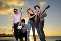 Cool young musical band posing at sunset Royalty Free Stock Photo