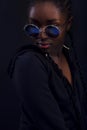 Cool young woman with dark skin wearing round sunglasses Royalty Free Stock Photo