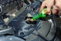 Coolant Oil change,Pouring oil to car engine, car mechanic changing motor.