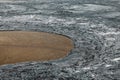 Cooled lava rocks surrounding a patch of red soil near Geldingadalir volcano in Iceland