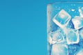 Cooling drink concept Ice cubes in a glass on blue Royalty Free Stock Photo