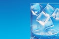 Cooling drink concept Ice cubes in a glass on blue Royalty Free Stock Photo