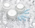 Cooling effect skin care creams surrounded by ice cubes Royalty Free Stock Photo