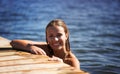 Cooling off. A pretty young woman taking a refreshing dip in the lake.