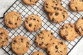Cooling rack with chocolate chip cookies on marble background Royalty Free Stock Photo