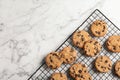 Cooling rack with chocolate chip cookies on marble background, top view Royalty Free Stock Photo