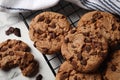 Cooling rack with delicious chocolate chip cookies on white marble table, closeup Royalty Free Stock Photo