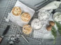 Cooling rack with delicious cupcakes on wooden background, top view Royalty Free Stock Photo