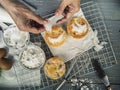 Cooling rack with delicious cupcakes on wooden background, top view Royalty Free Stock Photo