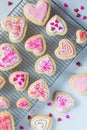 A cooling rack of heart shaped cookies.