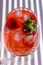 Cooling strawberry Sangria with sparkling wine, strawberry, ice cubes in champagne glass. Refreshing summer alcoholic cocktail Royalty Free Stock Photo