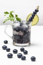 Cooling summer drink with blueberries and ice. Blueberries on the table