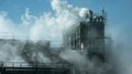 A cooling tower looms over the plant releasing plumes of steam as it helps regulate the temperature of the production