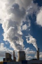 Steam clouds towering over the cooling towers and chimneys of a brown coal power plant in Germany Royalty Free Stock Photo