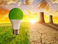 Cooling towers of a nuclear power plant in a devastated landscape and eco LED bulb in meadow. Royalty Free Stock Photo