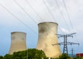 Cooling towers of a nuclear power plant and electricity pylons with high voltage power line Royalty Free Stock Photo