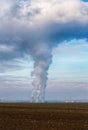 Cooling towers of nuclear power plant NPP Jaslovske Bohunice EBO in Slovakia. Clouds of thick smoke from chimneys on blue sky Royalty Free Stock Photo