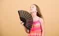 Cooling and ventilation. Summer heat. Fresh air. Kid girl fanning herself with fan. Conditioning system. Climate control Royalty Free Stock Photo