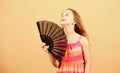 Cooling and ventilation. Summer heat. Fresh air. Kid girl fanning herself with fan. Conditioning system. Climate control Royalty Free Stock Photo