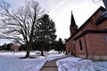 Coon valley cemetery in Winter with the 1876 evangelical Norwegian Lutheran church and drifters area bluffs covered in snow. Royalty Free Stock Photo