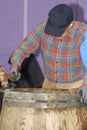 Cooper hamming a steel ring a barrel, Aberdeenshire, Scotland, UK