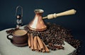 Cooper Turkish coffee pot, coffee beans, earthenware coffee Cup, cinnamon sticks, star anise, canvas napkin Royalty Free Stock Photo