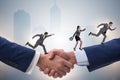 The cooperation concept with people running on handshake Royalty Free Stock Photo
