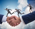 Cooperation concept with people running on handshake Royalty Free Stock Photo