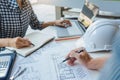 Cooperation Corporate designers in the office are working on a new project Planning blueprint Design at construction site at desk Royalty Free Stock Photo