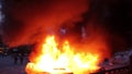 2 cop cars burn while riot officers throw tear gas