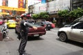 Cop commanding traffic in Chinatown, Bangkok Royalty Free Stock Photo