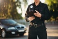 Cop with notebook in hands check the car Royalty Free Stock Photo