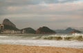 Copacabana beach striking by ocean waves, with Sugarloaf Mountain in backdrop, Rio de Janeiro of Brazil