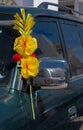 Detail of decorated car with yellow bouquet for the religious tradition of blessing cars in Copacabana, Bolivia