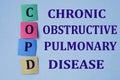 COPD - acronym gray color close-up on a light background with bright papers