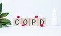 COPD. Text abbreviation on wood cubes blocks on light blue background. Most commonly diagnosed mental disorder of children. Close