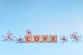 Cope word in wooden blocks on blue background. Coping with anxiety, stress, ptsd and depression during covid-19 pandemic Royalty Free Stock Photo