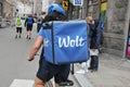WOLT BIKER WIH BLUE WOLT BACKPACK FOR DELIVERY Royalty Free Stock Photo