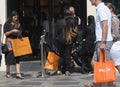 CONSUMERS WITH LOUIS VUITTON `S SHOPPING BAGS