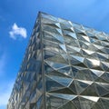 Modern futuristic office building with reflection of clouds and blue sky on the glass windows Royalty Free Stock Photo