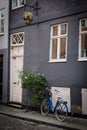 Copenhagen Denmark - August 2019. Street door and window grey wall and blue bike with basket in Copenhagen Old Town. Royalty Free Stock Photo