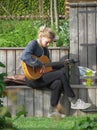 Girl tuning guitar in Copenhagen Royalty Free Stock Photo