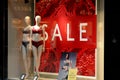 PEOPLE PAST BY SALE SIGN IN TUMPH LINGERIE STORE Royalty Free Stock Photo