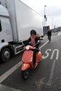 WOMAN RIDES SCOOTER IN COPENHAGEN