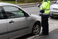 FEMALE PARKING INSPECTOR GIVES PARKING FINE TICKET Royalty Free Stock Photo