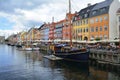 Copenhagen, Denmark- July 2021: Colorful old houses, cafes and restaurants, with boats docking along the canal of Nyhavn