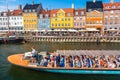 Copenhagen, Denmark - July, 2019: Copenhagen iconic view. Famous old Nyhavn port with colorful medieval houses and tourist ship in