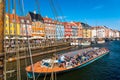 Copenhagen, Denmark - July, 2019: Copenhagen iconic view. Famous old Nyhavn port with colorful medieval houses and tourist ship in Royalty Free Stock Photo